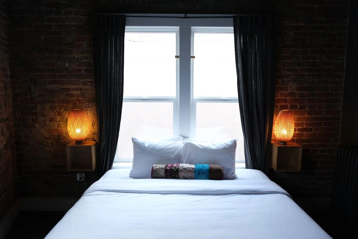 Cozy hotel bedroom with brick walls